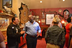 RETURNING CHAMPION: John Shoals, seen here enjoying a laugh with a supporter during his election night party, returned to the Grover Beach mayoral seat after a two-year absence, defeating incumbent Mayor Debbie Peterson. - PHOTO BY RHYS HEYDEN