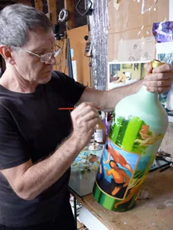 GIANTS OF THE ART WORLD : Paso Robles Art Association presents the Magnum Masterpieces Invitational Art Show and Fundraiser taking place March 31-April 20. Make a bid (a raffle is also happening) online or in a silent auction, or snap up creations at the “Buy it now price.” Proceeds will be used to establish and equip a new facility, The Showroom Gallery, located in downtown Paso Robles. The show features 30 Imperial size (6- liter) wine bottles hand painted by some of the area’s most collected artists, including Frank Licsko who is pictured (using oil paints). Area wineries, hotels, restaurants and many retail locations are participating. From April 23-May 24 works will be featured at The Showroom Gallery (on Pine Street, across from City Park). Info: 238-5473 or pasoroblesarts.org. - IMAGE COURTESY OF FRANK AND JOANNE LICSKO