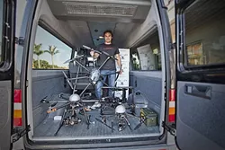 SELLING DRONES: Jason Lee sells Unmanned Aerial Vehicles (UAVs) for as little as $40 at his shop, Sky Pirate, in Pismo Beach. He believes that the rapid proliferation of drones demonstrates a need for regulations to govern their use. - PHOTO BY DAVID MINSKY