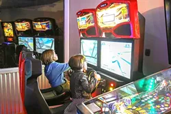 LET’S PLAY: You don’t have to be a kid to enjoy Gino’s Pizza’s air hockey, pinball, and video games. - PHOTO BY DYLAN HONEA-BAUMANN