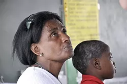 HEAD FUNGUS: This is the very first patient of the day in Bahia, a village near Dajabòn. The scabby yellow skin peeling off his head is a skin fungus. Unfortunately, the child is also diagnosed with scabies. The clinic pharmacy has medication to treat both. - PHOTO BY CAMILLIA LANHAM