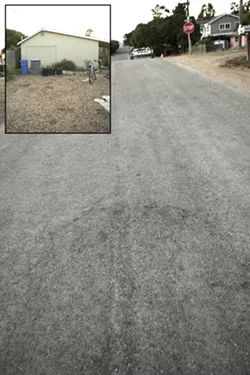 THE SCENE : The house, left, is where the shooting happened. The victim ran to the middle of the street, right, before he fell and died. - PHOTOS BY STEVE E. MILLER