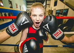 TOUGH CROWD: A young fighter learns the ins and outs of boxing at Knock Out Boxing Gym in Paso Robles. - PHOTO BY HENRY BRUINGTON