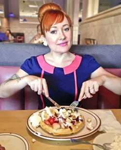 DINER QUEEN: Digging into a plate of “Alaskan Waffles,” aka waffles topped with vanilla ice cream at a dive-tastic diner in old Las Vegas earlier this year. Dessert disguised as breakfast is my husband’s favorite treat. This is obviously his meal. - PHOTO COURTESY OF HAYLEY THOMAS