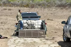 INTRUDERS! : Several agencies cooperated on investigating a panga beached near San Simeon on Sept. 6. They arrested 20 suspects and seized more than 3,000 pounds of marijuana. More images are available on our Slideshow page. - PHOTOS BY STEVE E. MILLER
