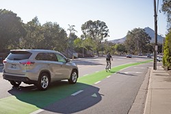 GREEN LANES:  SLO hopes to introduce more &ldquo;protected bike lanes,&rdquo; such as this stretch on California Boulevard, to separate bikers from high-speed traffic. - PHOTO BY KAORI FUNAHASHI