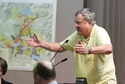 I’LL GIVE YOU FOUR! : Jim Duenow offers to beat Copeland’s offer for a piece of land by almost $3 million at the July, 1 city council meeting. And, he’ll pay for parking. - PHOTO BY STEVE E. MILLER