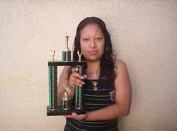 TROPHY MOM : Maria Hernandez holds a trophy she won as the first student in Atascadero High School history to earn all her credits in two years. - PHOTO COURTESY OF ECONOMIC OPPORTUNITY COMMISSION