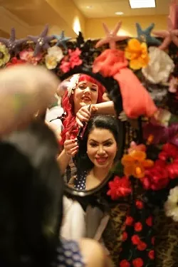 DO IT UP RIGHT! : Martina Godwin of San Luis Obispo-based Hep Kat Clothing & Beauty Parlor does up Los Angeles resident Grace Chavez’s hair in the vendor area at Viva Las Vegas. The Hep Kat gals did between 50 and 60 do’s a day, and Hep Kat owners Terry and Brittany Brown sold a ton of clothing.