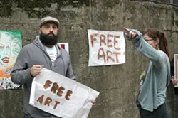 CO-CONSPIRATORS! : Neal Breton (the one with the puzzled look on his face) will run an “art truck” and New Times editor Ashley Schwellenbach (hiding behind her own arm) will orchestrate the shenanigans of the entire Box City event on Feb. 25. - PHOTO BY GLEN STARKEY