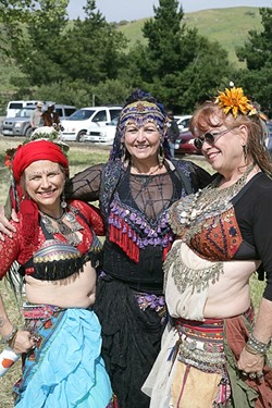 THREE QUEENS :  A trio of belly dancers struck a pose before performing for the crowd. - PHOTO BY GLEN STARKEY