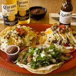 TRY ’EM : The delicious tacos at Zorro’s satisfy during happy hour. At $2 each, they pair well with a cold Corona and fresh chips and salsa. - PHOTO BY STEVE E. MILLER
