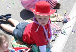 WONDER YEARS : A cowboy-hatted tyke gazes in amazement as the parade rolls past. - PHOTO BY GLEN STARKEY