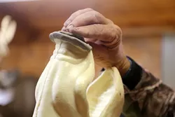 PERFECT CONTOUR: Don uses clay to shape the nose on the form he is about to mount the boar hide to. - PHOTO BY DYLAN HONEA-BAUMANN