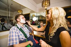 ALL DONE UP: Emily, a sales rep for SunnyCountry radio in Santa Maria, kept Jono’s attention while putting on his clown mask. - PHOTO BY HENRY BRUINGTON