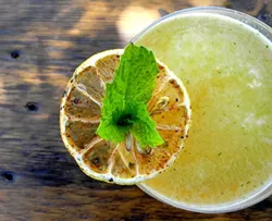 COCKTAIL RANGE: Bourbon, yellow chartreuse, mint, lemon, and honey meet up in the Rancher for a menagerie of mouth-watering flavor from S.Y. Kitchen Mixologist Alberto Battaglini. - PHOTOS BY ROB STARK, COURTESY OF S.Y. KITCHEN