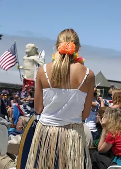 CALIFORNIA GIRL : A hula girl watches the rest of the parade after her group finishes their hula duties. - PHOTO BY GLEN STARKEY