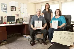 SUCCESS FOR YOUNG ENTREPRENEURS: With their original brainstorming map of Biz Whiz Academy in the foreground, (left to right) CEO and Founder Erik Amato, Managing Partner Isabel Amato, and Operations Manager Heather Perry are all set up to help kids and teenagers start their own businesses. - PHOTO BY STEVE E. MILLER