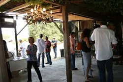 DEFINITE CRAVING: Vines intermingle with chandelier baubles and ancient barn wood at the site of what will become LXV’s new wine lounge, located in Westside Paso Robles. The winery recently released two new wines: Dark Romance, comprised of 100 percent chenin blanc, and Secret Craving, a blend of cab franc, syrah, and merlot. - PHOTO BY HAYLEY THOMAS