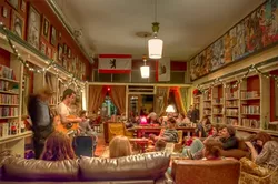 THE PERFECT PARTS: apRoberts and Christopher’s Exquisite Corpse fits perfectly into an unusual space above the built-in bookshelves and below the ceiling at Kreuzberg’s original location on Monterey St. - PHOTO COURTESY OF JIMMY APROBERTS AND BRIAN CHRISTOPHER