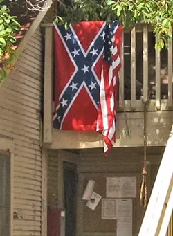 A CLOSER LOOK : A hangman’s noose can also be seen tied on a railing near the Confederate flag. Between them flies an American flag. - NEW TIMES STAFF PHOTO