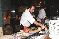 SOUSSICAL: Sous chef David Marks keeps the fires roaring for their many guests served at Ember nightly. - PHOTO BY DAN HARDESTY
