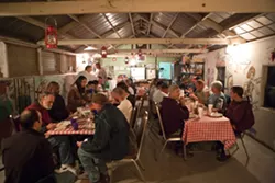 GET OUT : When New Times visited Sunny Acres in December 2008, residents used the “ag barn” as a communal dining room. A recent injunctive order, however, will force ranch owner Dan DeVaul to vacate most of the structures previously used to house and feed residents. - FILE PHOTO BY STEVE E. MILLER