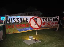 TAKING A STAND : Dennis Apel, McGregory Eddy, and Father Steve Kelly were arrested during a protest against missile testing such as the one pictured. - PHOTO BY NICHOLAS WALTER
