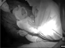 COMBATIVE OR COOPERATIVE? : A Taser video shows Peter Hewitt relinquishing a baby he was accused of kidnapping.