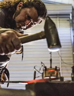 TINKER TAILOR : Randolph hammers the scorching steel to draw it out and elongate it. - PHOTO BY KAORI FUNAHASHI