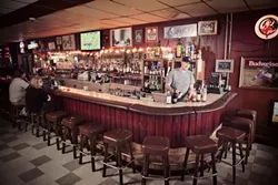 SIT ON DOWN: At Whiskey and June in Atascadero, you get all the dive bar experience with a craft cocktail menu. Pictured, co-owner Daniel Green mans the bar. - PHOTO BY STEPHEN DUMMIT