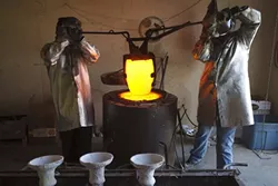 The crucible is removed from the furnace. - PHOTO BY STEVE E. MILLER
