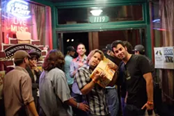 IS IT TICKING? : Brad Daane of Truth About Seafood listens to his prize box at the New Times Music Awards as fellow band mate Sean Flanegan (right) looks on. - PHOTO BY STEVE E. MILLER