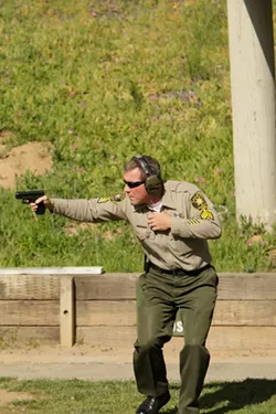 THE GOOD: Years of intensive training allow SLO County Sheriff’s Department Senior Range Master Steve Odom to fire his weapon while evading returned fire, exactly the kind of training needed by a citizen hoping to protect their home with a firearm. Most gun owners lack such training. - PHOTO BY STEVE E. MILLER