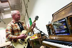 HEALER AND BUILDER: Dr. Clint Slaughter, one of the founders and owners of SLO MakerSpace showcases one of his creations, The Music Machine, which has multiple MIDI inputs for different musical instruments to be played through the computer shown above the keyboard. - PHOTO BY STEVE E. MILLER