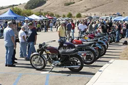 SHOW BIKES : Vintage bike aficionados wander between a line of classic bikes and vendors’ booths during the recent annual SLO Classic Motorcycle Show at Mountainbrook Community Church. - PHOTOS BY STEVE E. MILLER