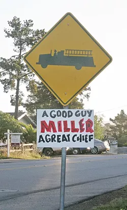 SIGNS OF SUPPORT : Cambria residents are set to protest the firing of popular former fire chief Mark Miller at the April 28 CSD Board of Directors meeting. - PHOTO BY MATT FOUNTAIN