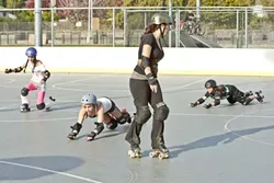 WONDER WOMEN: Most of the participants in the junior derby league are still learning to skate, and fall. - PHOTO BY STEVE E. MILLER