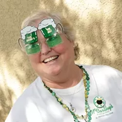 THE DRINKS ARE ON HER : DeAnn Troutner was peddling green beer, Jameson, and corned beef and cabbage burritos. - PHOTO BY STEVE E. MILLER