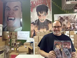 FAIR TRADE: Arthur Goldiner stands in Scarecrow Vampire Fangs’ Grover Beach office with his popular fang teeth, which will be given in return for just a little blood during a blood drive with United Blood Services on Oct. 29. - PHOTO BY REBECCA LUCAS
