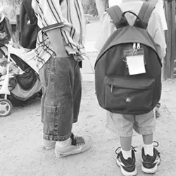 NO REGULAR ROOF : Hundreds of local schoolchildren are homeless. These boys at a shelter received donated backpacks filled with school supplies. - FILE PHOTO BY STEVE E. MILLER