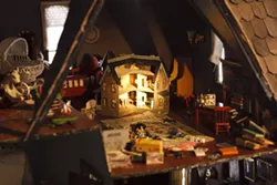 TINY VOYEURS : Peeking into the attic of Kroll’s dollhouse feels almost like spying, it’s so detailed. In a rather witty touch, the artist has even included a miniature replica of the dollhouse itself. Wow.