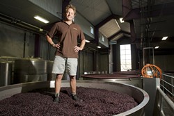 WALKING ON WINE :  Fin du Fresne, winemaker at Chamisal Vineyards, showed off his ability to walk on a Pinot Noir cap in his winemaking facility. - PHOTO BY STEVE E. MILLER