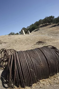 VALLEY TRASH : Previous drilling operations have scarred Huasna with leaking wells and leftover trash. Ironically, Excelaron had to pay for an anthropological study to determine if the leftover debris at the proposed drilling site was historically significant. - PHOTO BY STEVE E. MILLER