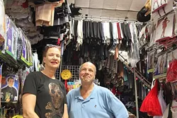 FOR A LIMITED TIME ONLY: Costume Caper’s co-owners Debi Hernandez and Keith Wetzel stand among the hundreds of costumes that they have rented out to customers and theatre companies over the years. After 30 years of business, the store will be closing in November, making this Halloween season their last. All inventory is on sale for at least 30 percent off, found at 2146 Parker Street. - PHOTO BY REBECCA LUCAS