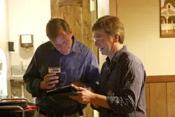 SCOPING THE GOOD NEWS : Through the magic of technology, Eric Howell and his unofficial campaign assistant, Don Stewart, monitored Howell’s winning bid for a seat on the Pismo Beach City Council. - PHOTO BY NICK POWELL