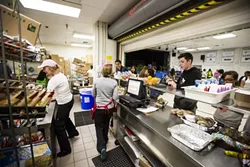 LUNCHTIME!: As Laguna’s roughly 700 students spilled into the cafeteria for lunch, the unflappable food service workers behind the counter kicked into high gear. - PHOTO BY HENRY BRUINGTON