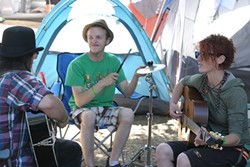 PRACTICE MAKES PERFECT :  (left to right) Sam Boorman, Molly Reeves, and Kenneth Davis&mdash;three members of the six-piece Red Skunk Jipzee Swing Band&mdash;practice in their campsite a few days before their main stage appearance. - PHOTO BY GLEN STARKEY