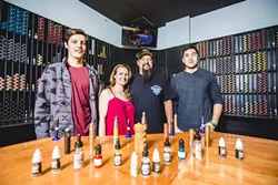 VAPE ON: From left, Frankie Compston, Kristie Compston, Frank Compston, and Jackson Pham are ready to assist you with your vaporizing needs. - PHOTO BY HENRY BRUINGTON