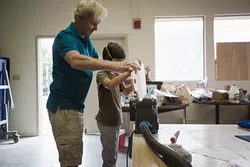 HANDS-ON, RIGHT ON : Riley Logan gets a hand from technical education teacher Chris de Firmian. - PHOTO BY KAORI FUNAHASHI